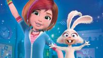 A girl with short red hair wearing a blue top is waving her arm up in the air, standing beside a white rabbit in front of a blue background.