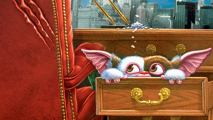 A cute, tiny creature with big ears peeking through a desk drawer.