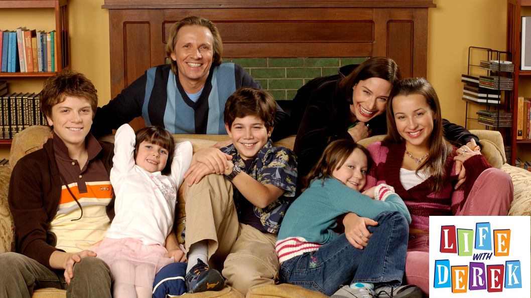 A family of six sitting on the couch posing for a photo, with a logo that says Life with Derek.